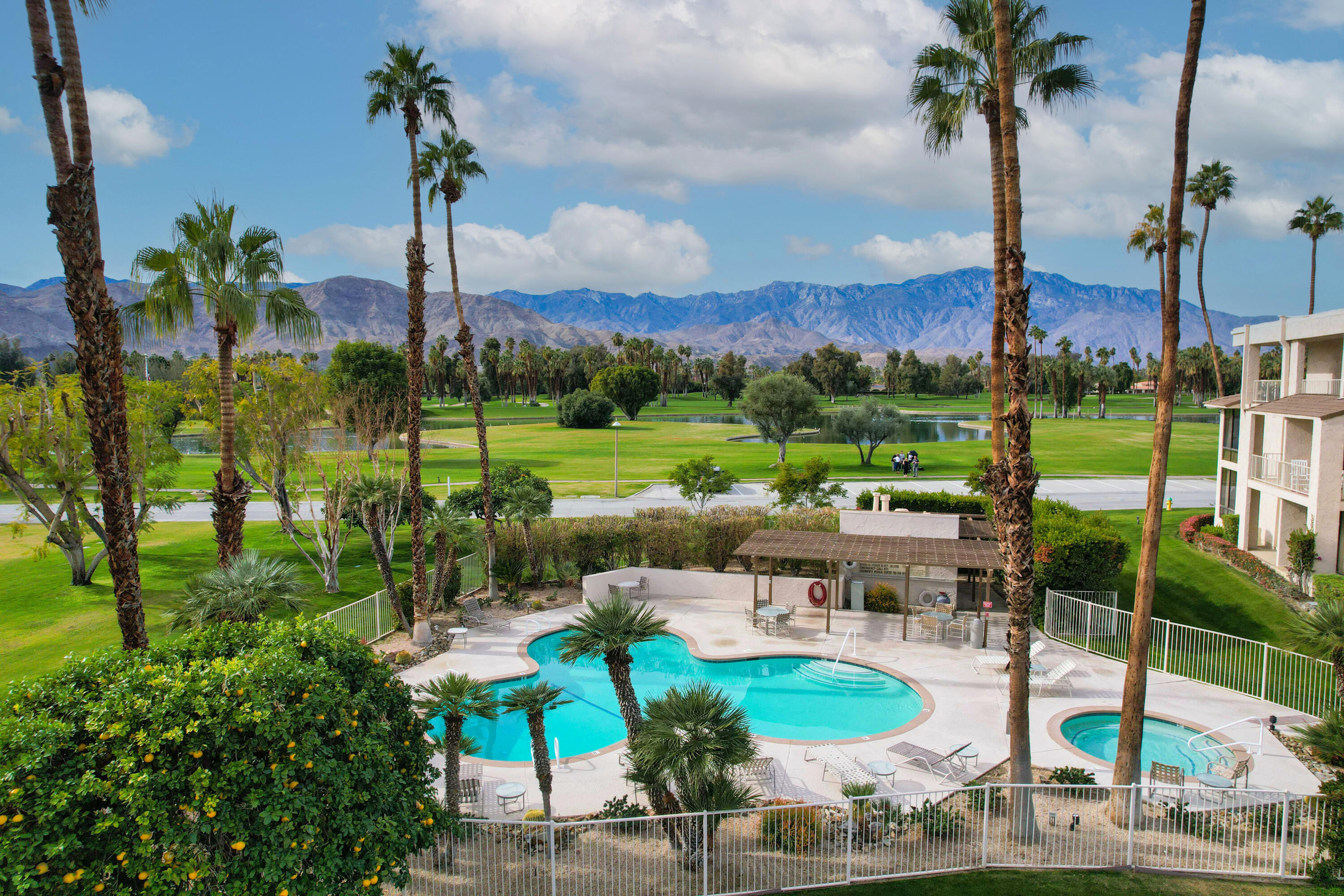 910 Island Drive, Unit 211 Rancho Mirage, CA 92270 - Photo 34 of 38 a view of a lake with a sitting area