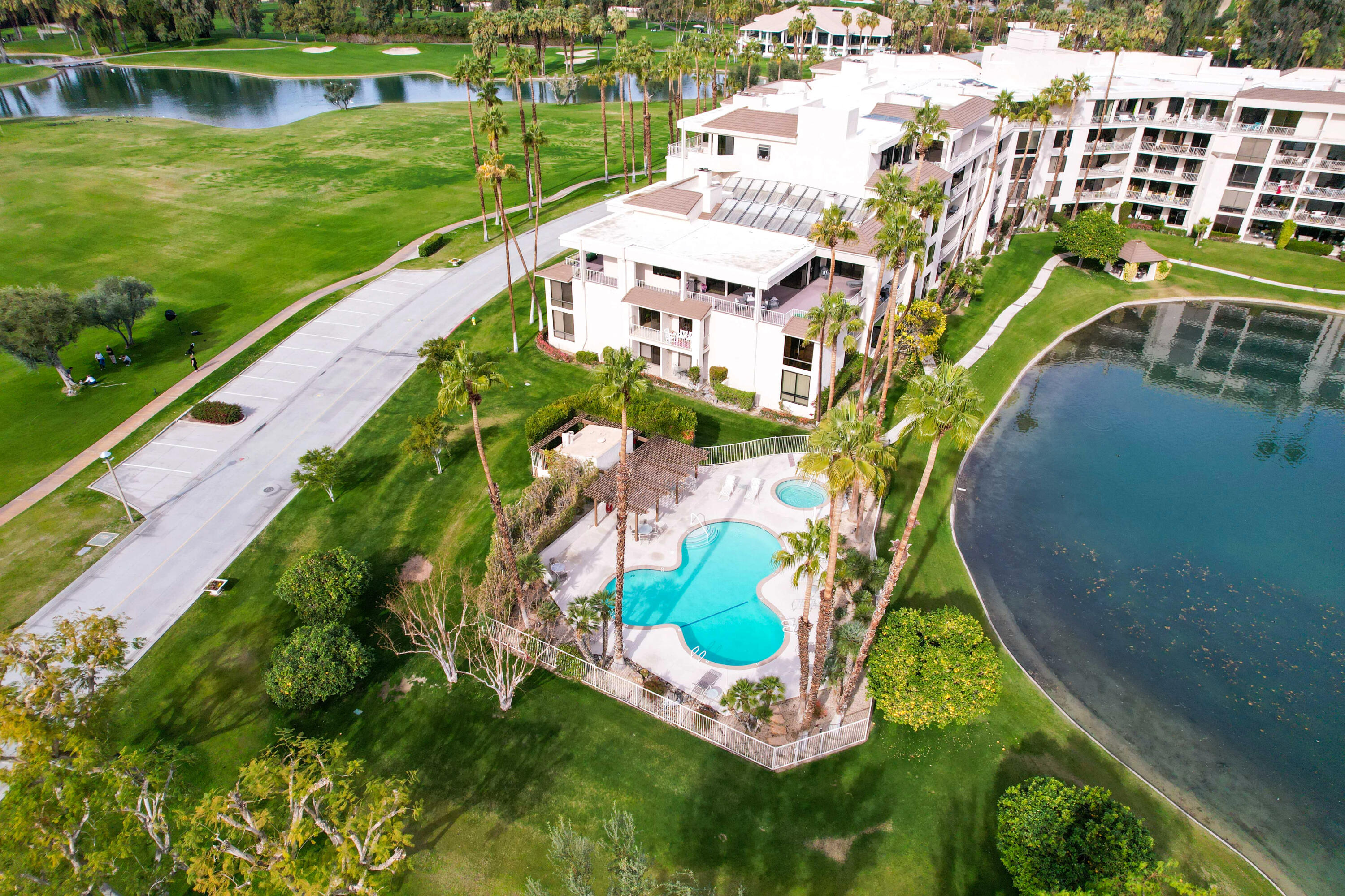 910 Island Drive, Unit 211 Rancho Mirage, CA 92270 - Photo 35 of 38 an aerial view of a house with a yard and lake