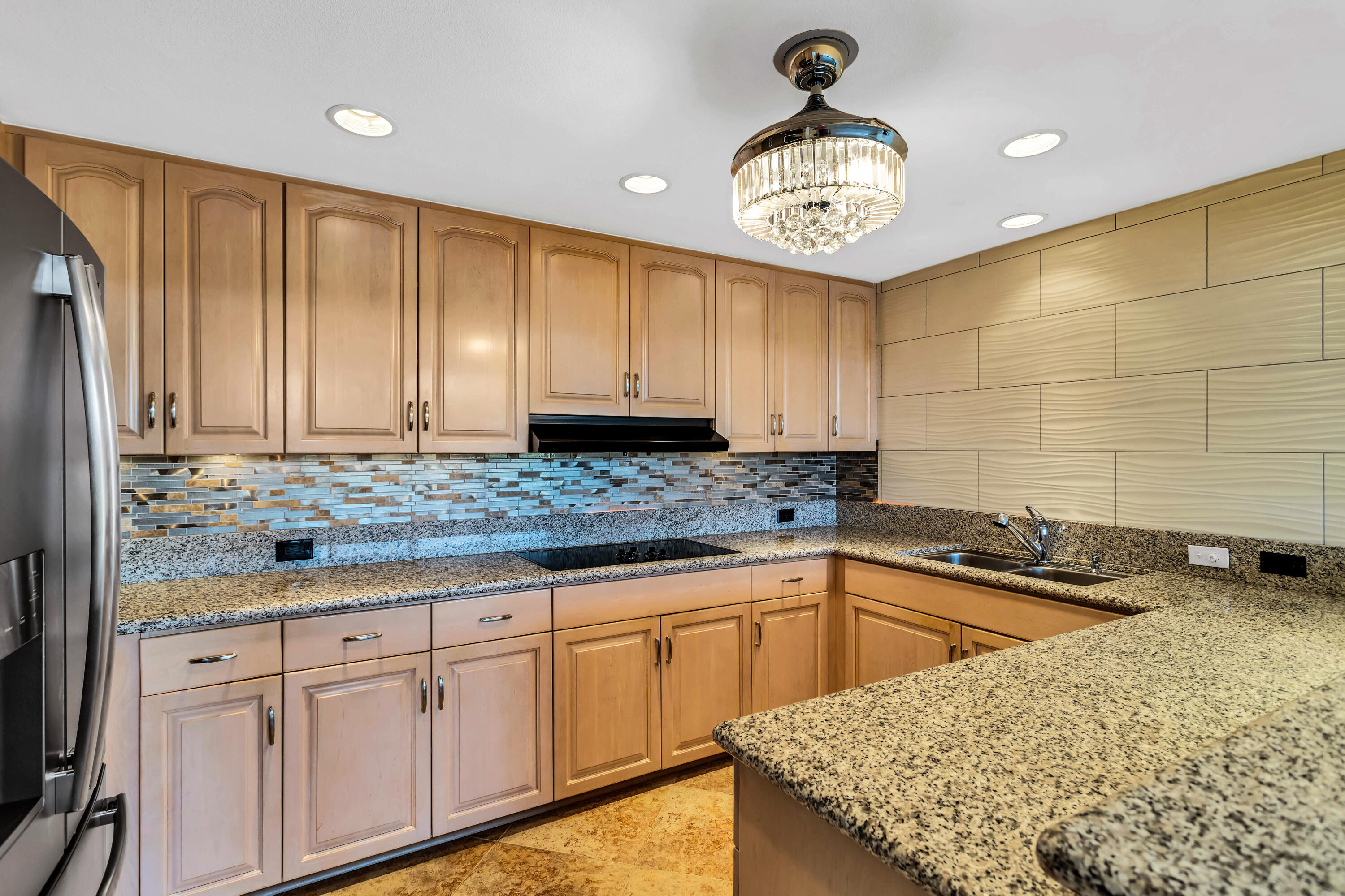 910 Island Drive, Unit 211 Rancho Mirage, CA 92270 - Photo 10 of 38 a kitchen with granite countertop a sink a stove and cabinets