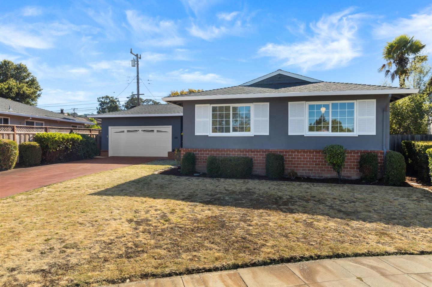 228 Spuraway Drive San Mateo, CA 94403 - Photo 1 of 20 a front view of a house with a yard and garage