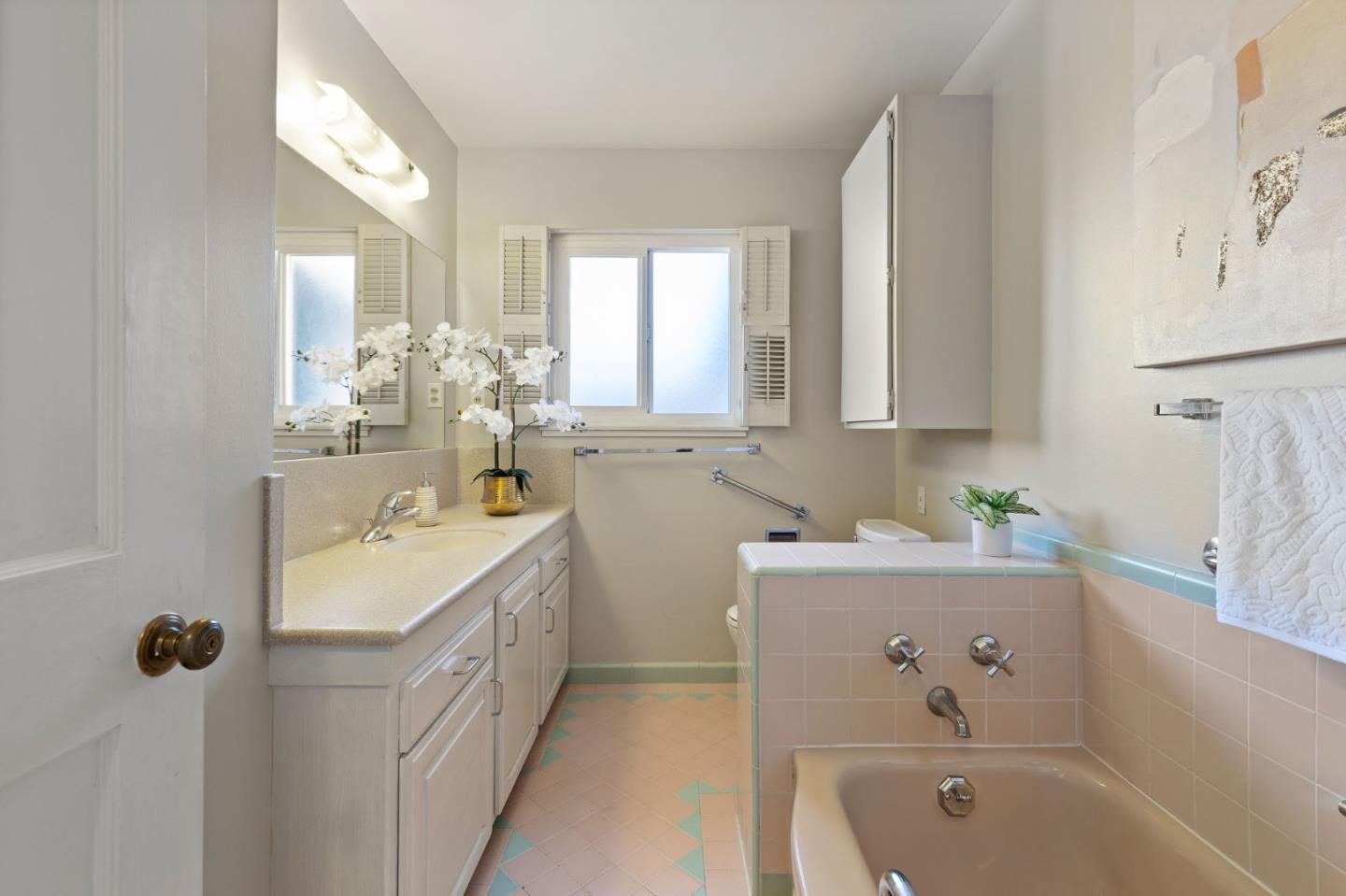 228 Spuraway Drive San Mateo, CA 94403 - Photo 14 of 20 a bathroom with a sink a large mirror and a bathtub