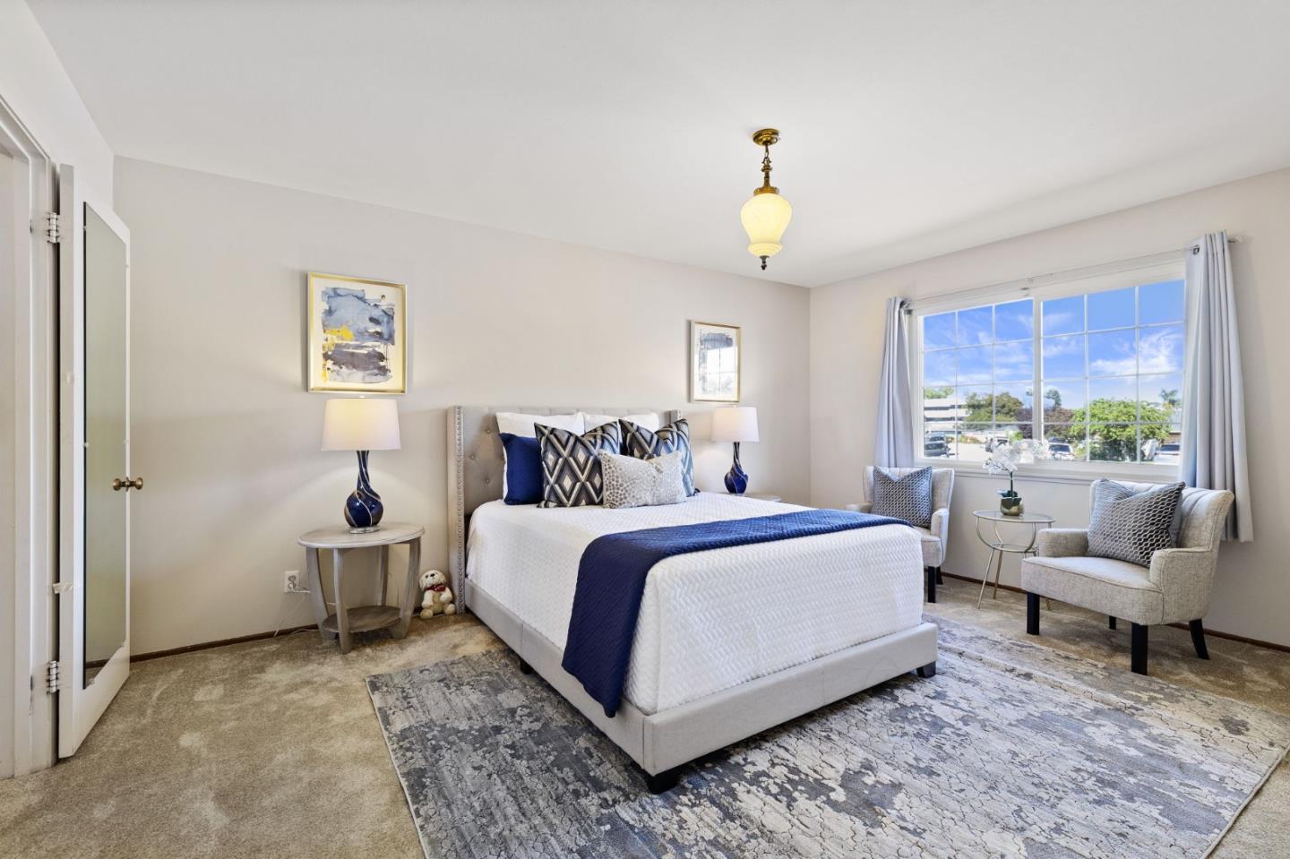 228 Spuraway Drive San Mateo, CA 94403 - Photo 15 of 20 a bedroom with a bed and a chandelier