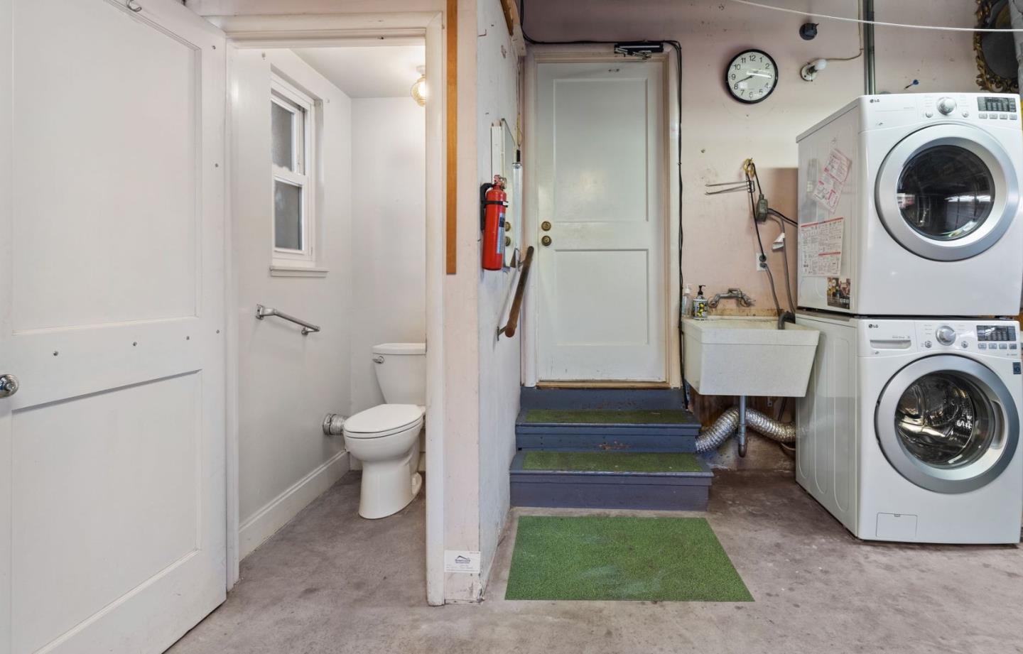 228 Spuraway Drive San Mateo, CA 94403 - Photo 17 of 20 a view of a hallway with washer and dryer