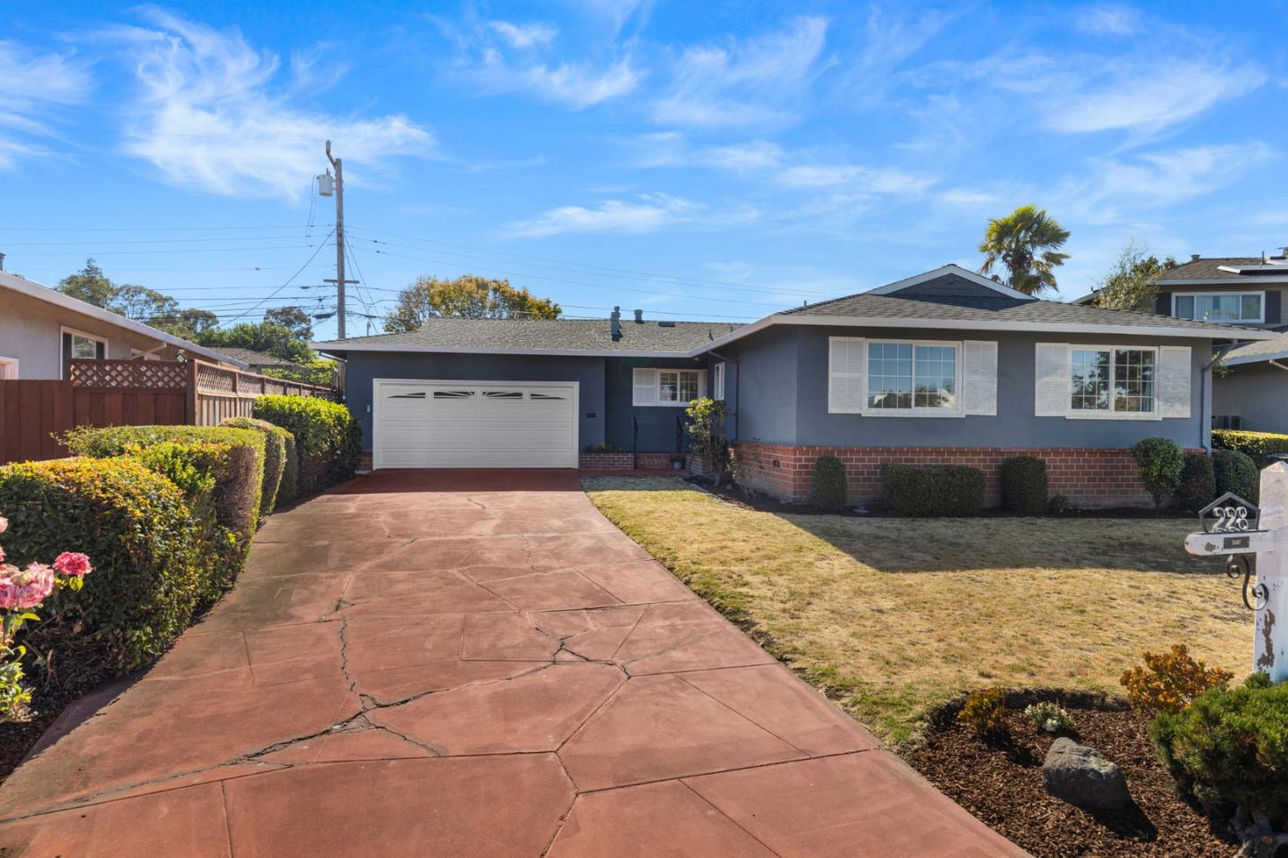 228 Spuraway Drive San Mateo, CA 94403 - Photo 2 of 20 a front view of a house with a yard