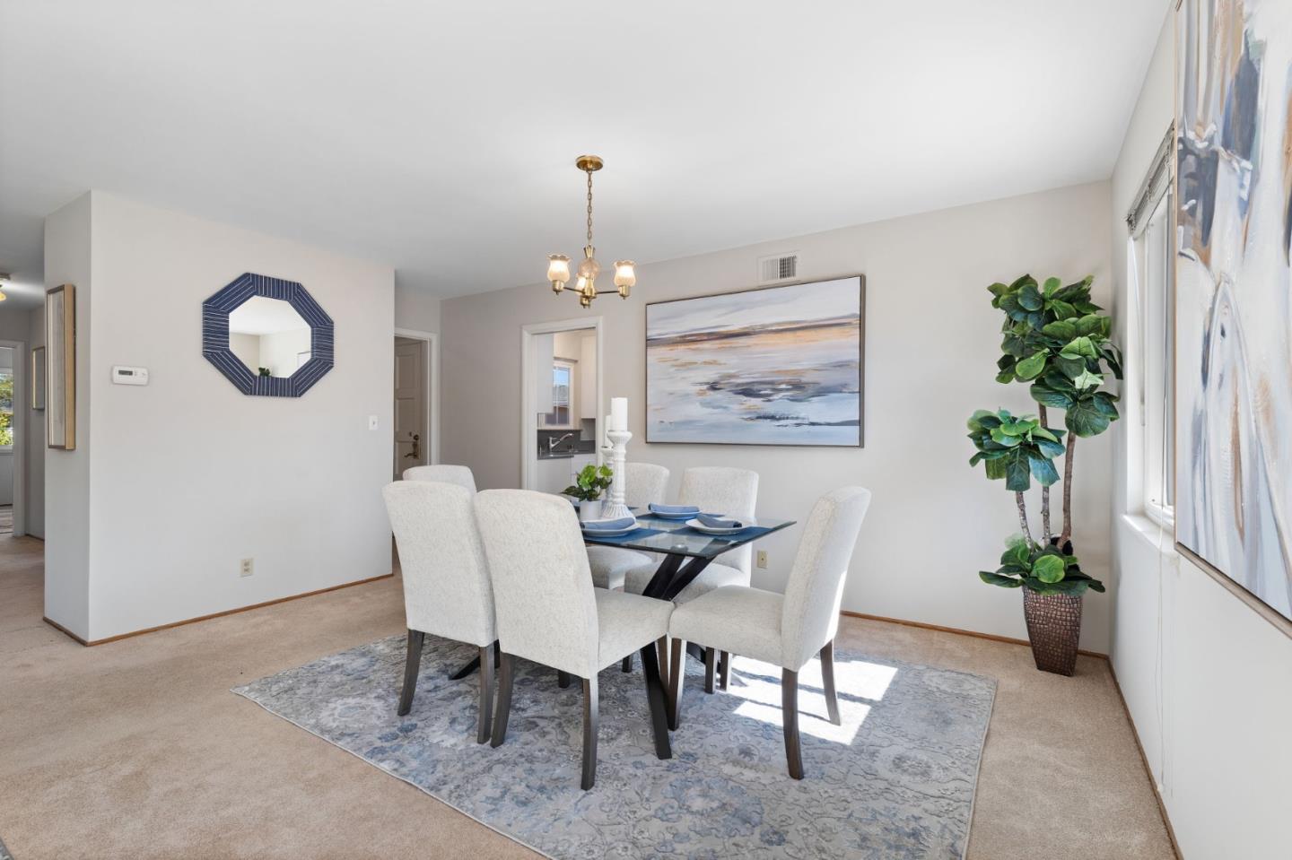 228 Spuraway Drive San Mateo, CA 94403 - Photo 8 of 20 a dining room with furniture and a potted plant