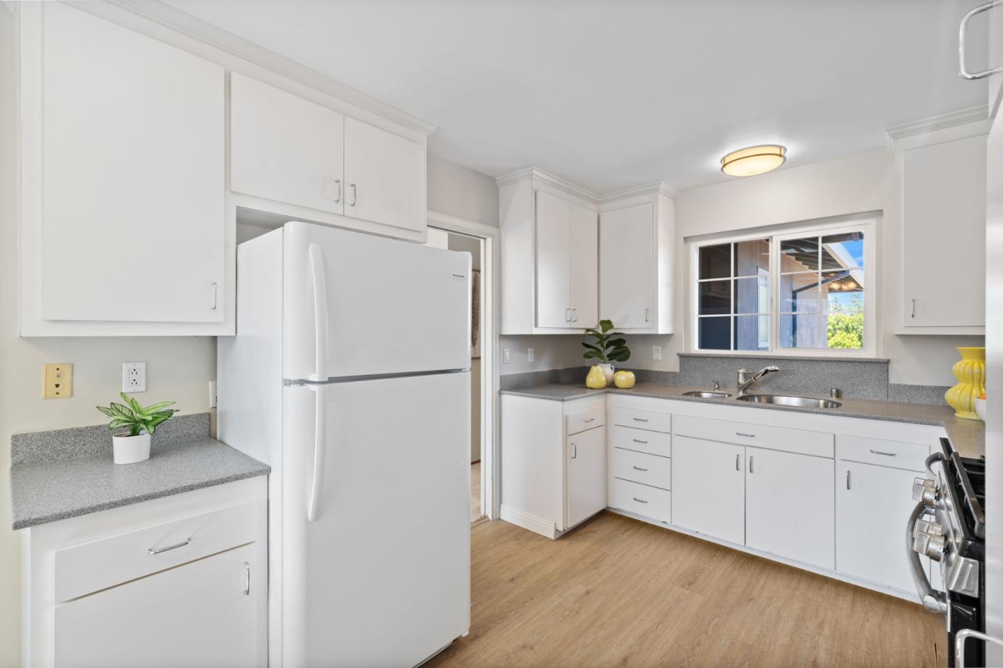 228 Spuraway Drive San Mateo, CA 94403 - Photo 10 of 20 a kitchen with white cabinets and white appliances