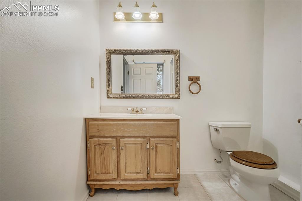 23555 Murphy Road Calhan, CO 80808 - Photo 33 of 49 Bathroom featuring vanity, tile patterned floors, and toilet