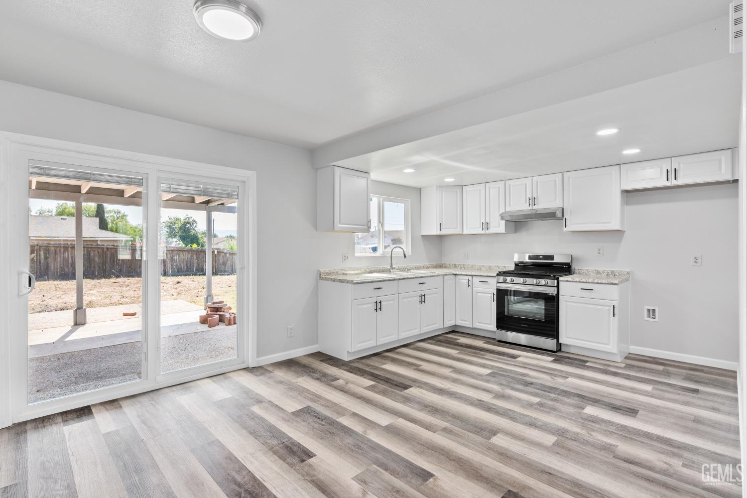 Undisclosed Address Santa Maria, CA 93455 - Photo 13 of 34 a kitchen with granite countertop white cabinets and white appliances