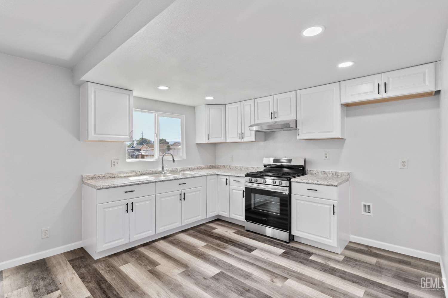 Undisclosed Address Santa Maria, CA 93455 - Photo 14 of 34 a kitchen with stainless steel appliances granite countertop a stove a sink and a refrigerator
