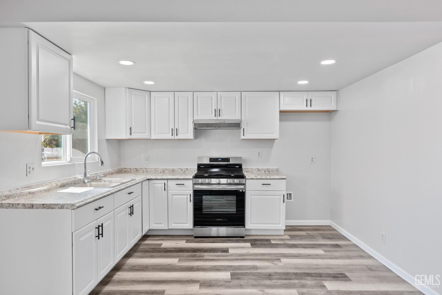 Undisclosed Address Santa Maria, CA 93455 - Photo 15 of 34 a kitchen with stainless steel appliances granite countertop a stove and white cabinets