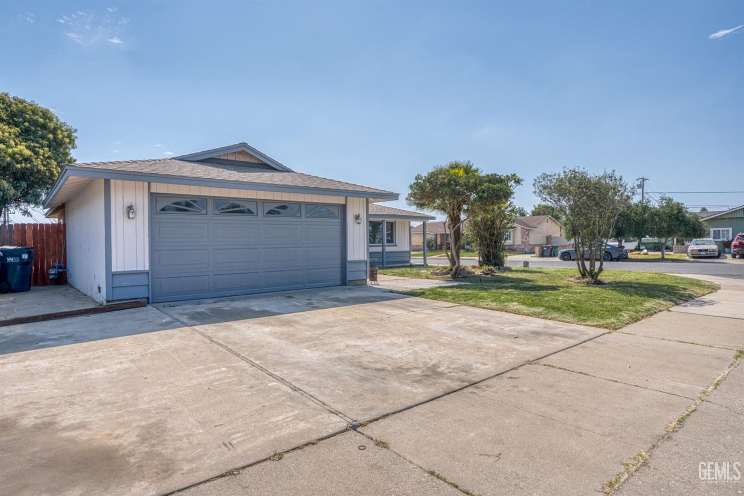 Undisclosed Address Santa Maria, CA 93455 - Photo 4 of 34 a front view of a house with a yard and garage