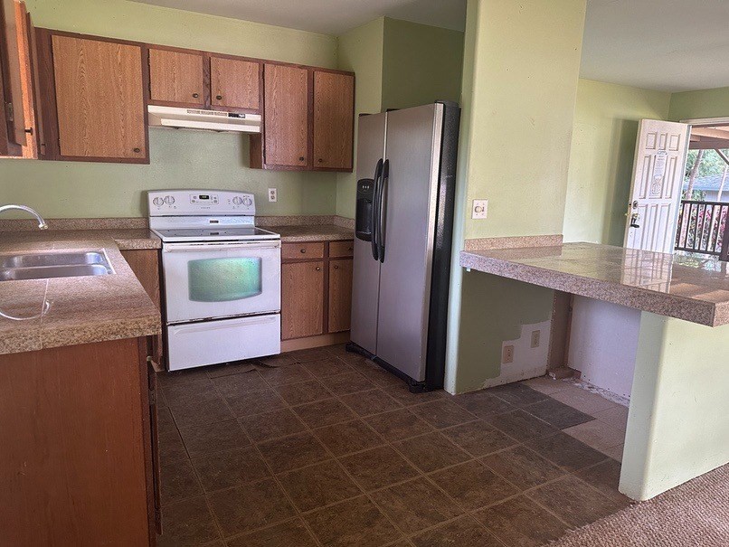 4914 D Hekili Road Kapaa, HI 96746 - Photo 8 of 17 a kitchen with a refrigerator sink and stove