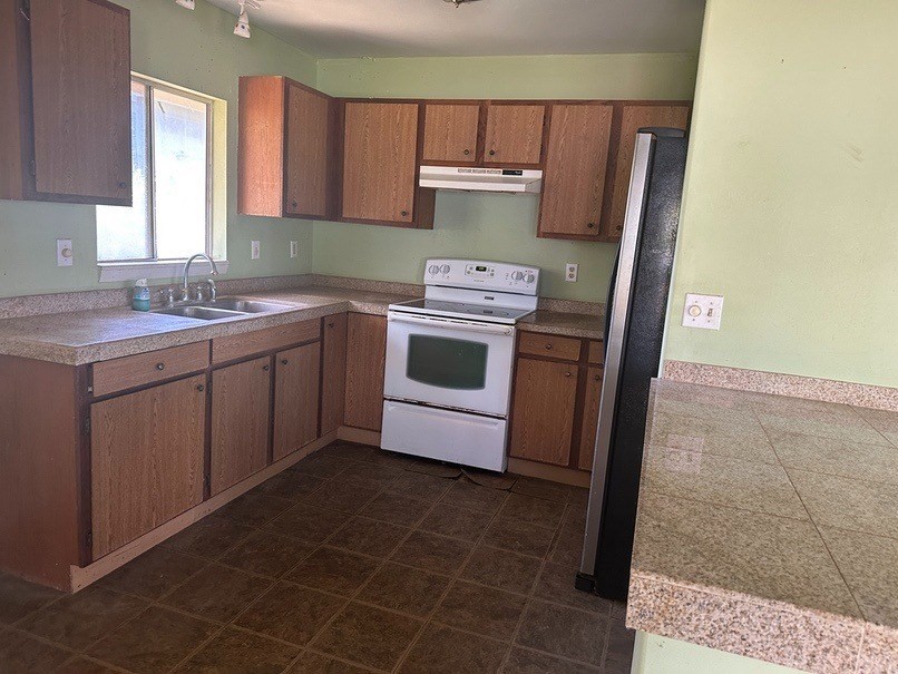 4914 D Hekili Road Kapaa, HI 96746 - Photo 9 of 17 a kitchen with a stove a sink and a refrigerator