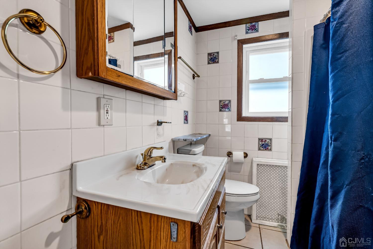 40 Farrington Road Old Bridge, NJ 07747 - Photo 15 of 49 a bathroom with a sink and a mirror