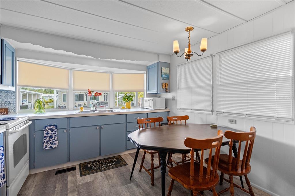 24437 Harbor View Road, Unit 55 Punta Gorda, FL 33980 - Photo 7 of 23 a kitchen with a dining table chairs and sink