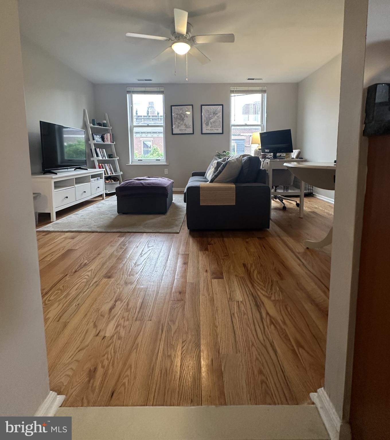 1608 South Street, Unit 3 Philadelphia, PA 19146 - Photo 2 of 10 a living room with furniture and a flat screen tv