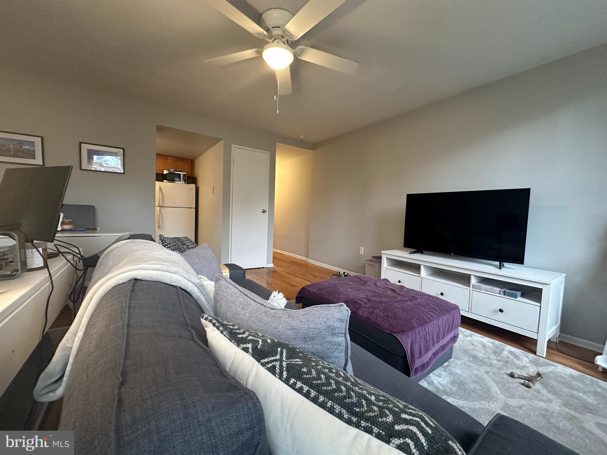 1608 South Street, Unit 3 Philadelphia, PA 19146 - Photo 3 of 10 a bedroom with a bed and a flat screen tv