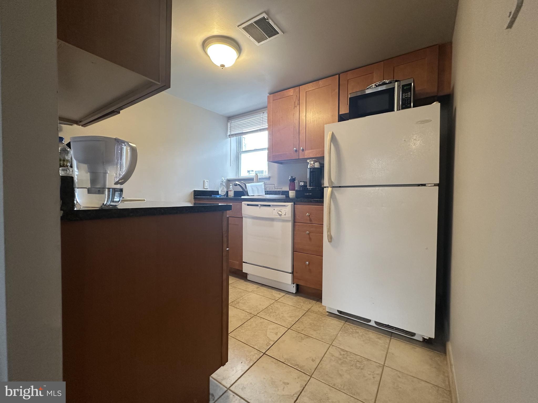 1608 South Street, Unit 3 Philadelphia, PA 19146 - Photo 4 of 10 a kitchen with kitchen island a counter top space cabinets and stainless steel appliances