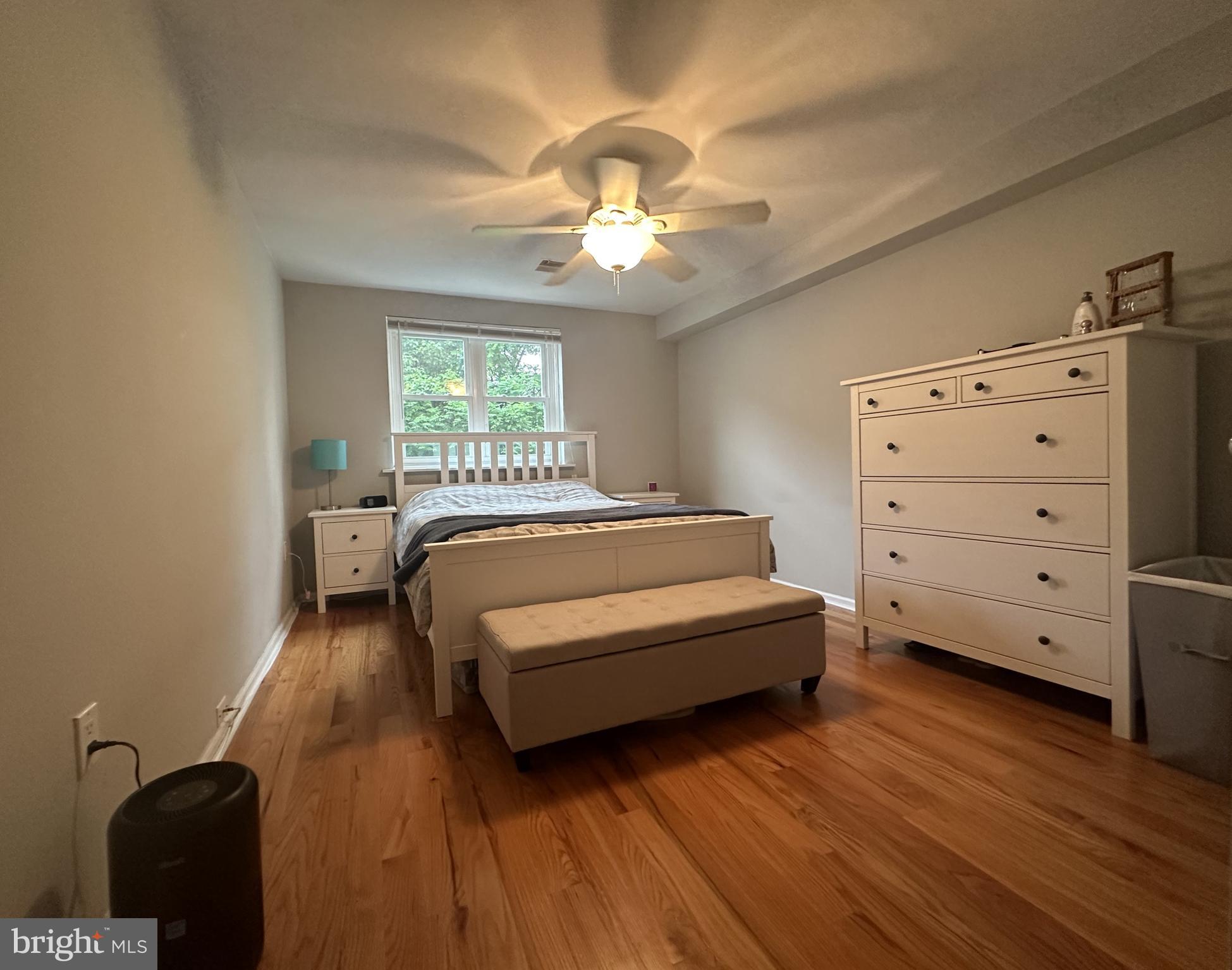 1608 South Street, Unit 3 Philadelphia, PA 19146 - Photo 6 of 10 a bedroom with a bed and a chandelier