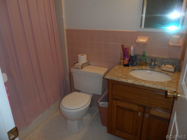1272 Tuggle Road Farmville, VA 23901 - Photo 11 of 17 a bathroom with a granite countertop toilet a sink and a mirror