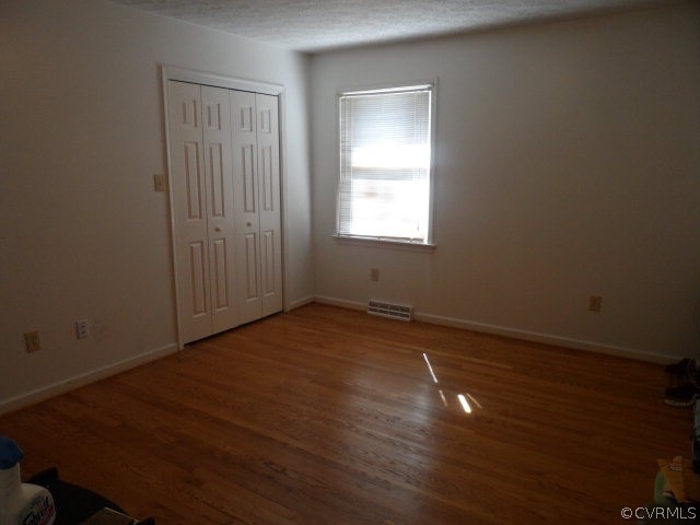 1272 Tuggle Road Farmville, VA 23901 - Photo 13 of 17 an empty room with wooden floor and windows