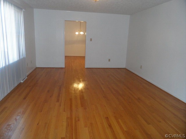 1272 Tuggle Road Farmville, VA 23901 - Photo 4 of 17 an empty room with wooden floor and windows
