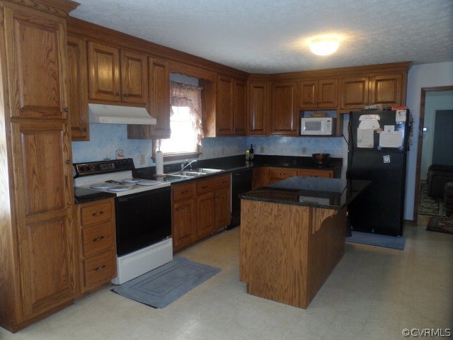 1272 Tuggle Road Farmville, VA 23901 - Photo 8 of 17 a kitchen with a sink stove and refrigerator