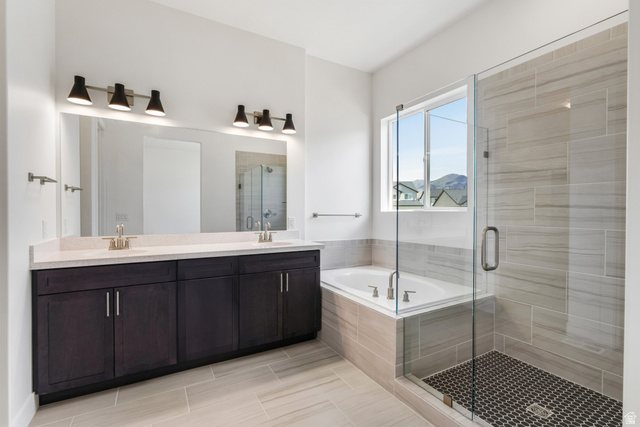 43 South Crimson Way, Unit 311 Mapleton, UT 84664 - Photo 15 of 28 Bathroom featuring a dual vanity with dark wood-finish cabinetry, a large frameless mirror, and modern light fixtures