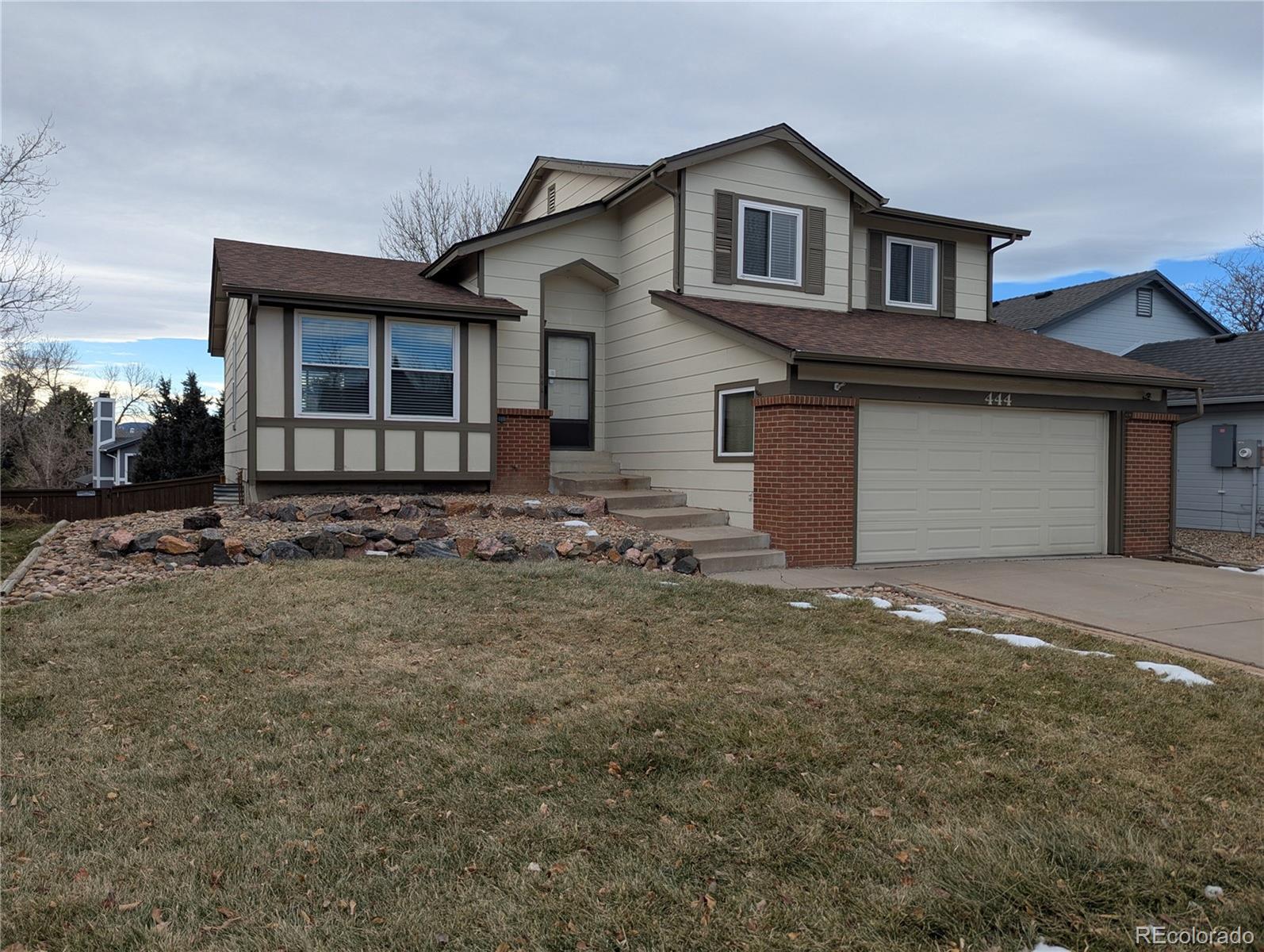 a front view of a house with garden