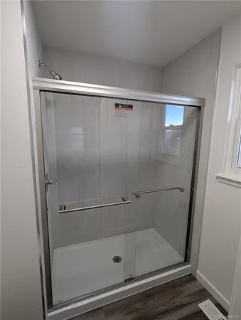 a view of a yard with wooden fence