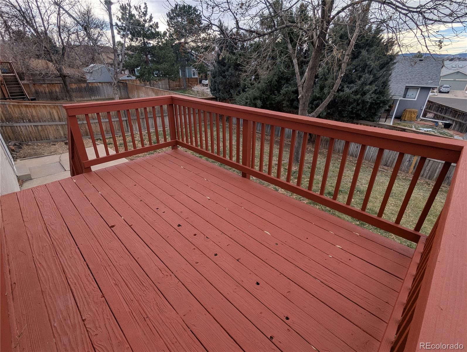 444 Spring Grove Avenue Highlands Ranch, CO 80126 - Photo 19 of 21 a view of deck with wooden floor and fence