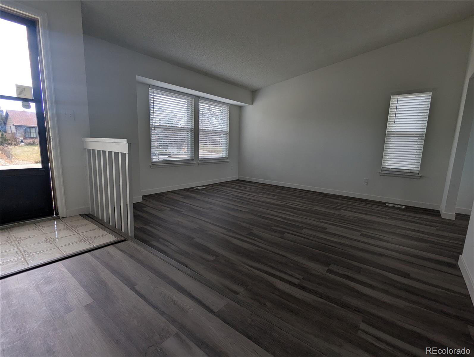 444 Spring Grove Avenue Highlands Ranch, CO 80126 - Photo 21 of 21 an empty room with wooden floor and windows