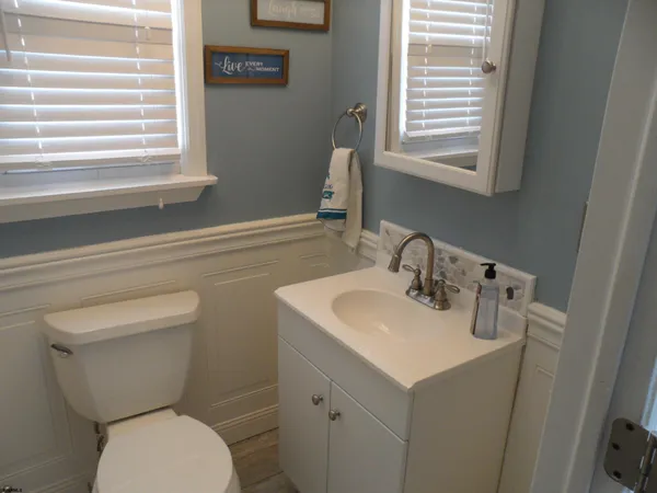 a bathroom with a toilet sink and mirror