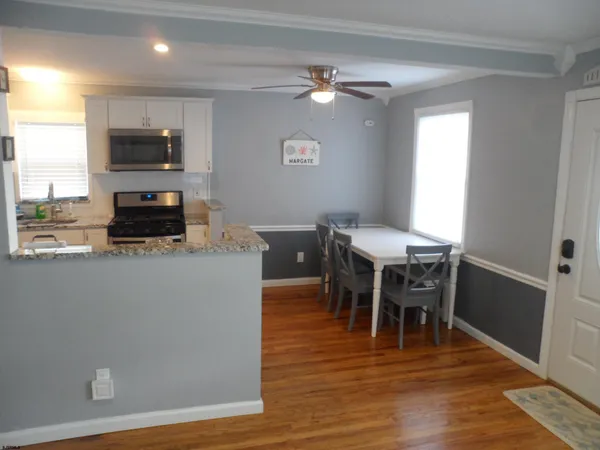 a view of a dining room with furniture window and wooden floor