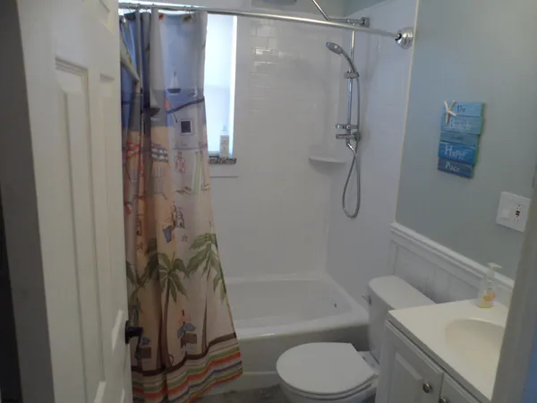 a bathroom with a shower a toilet and a sink