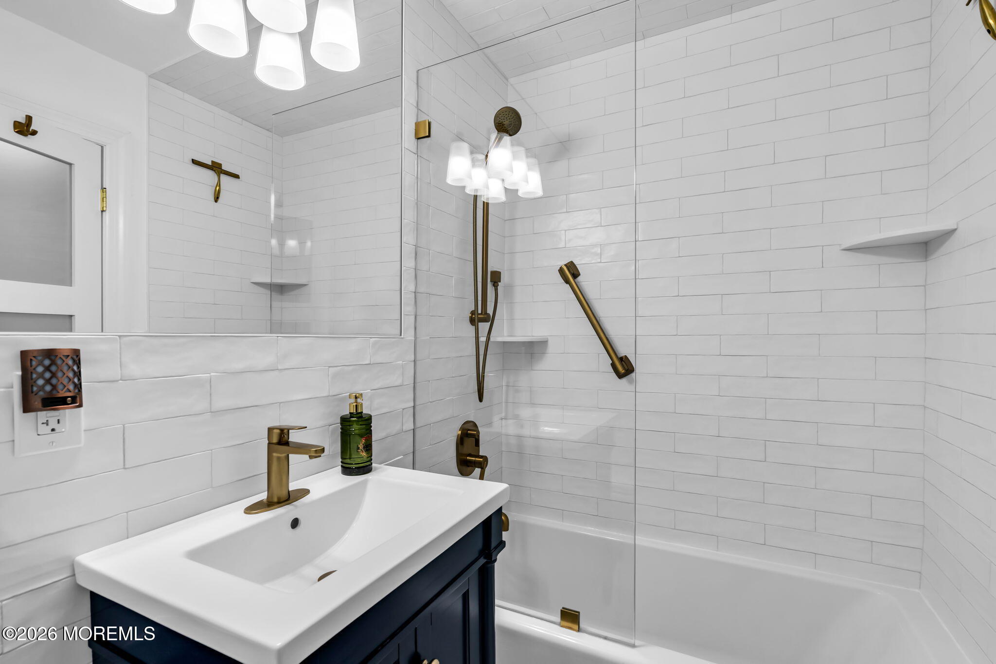 28 Riverside Avenue, Unit 1N Red Bank, NJ 07701 - Photo 3 of 40 a bathroom with a sink a mirror and a bathtub