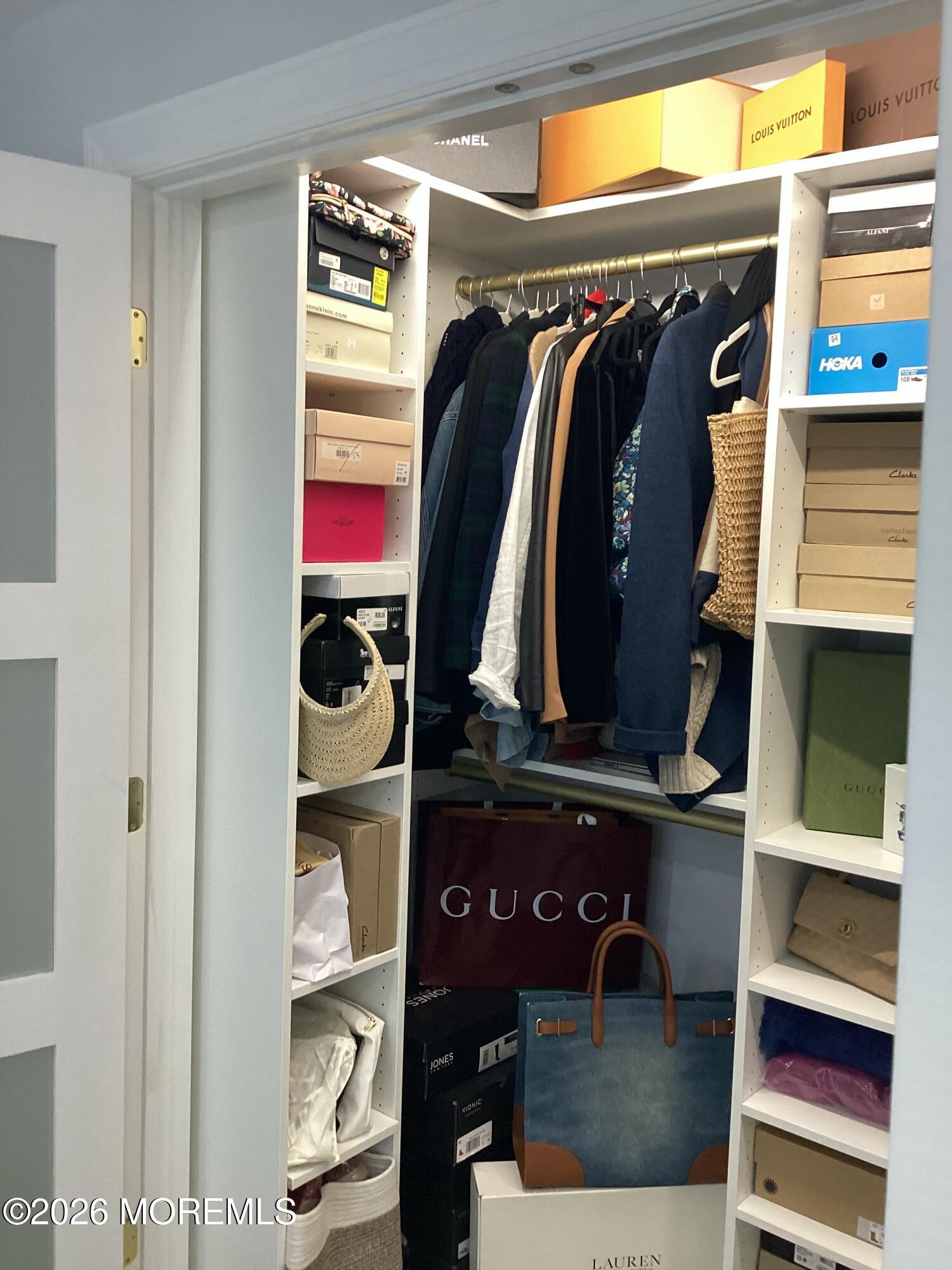 28 Riverside Avenue, Unit 1N Red Bank, NJ 07701 - Photo 31 of 40 a view of walk in closet with clothes and shoes