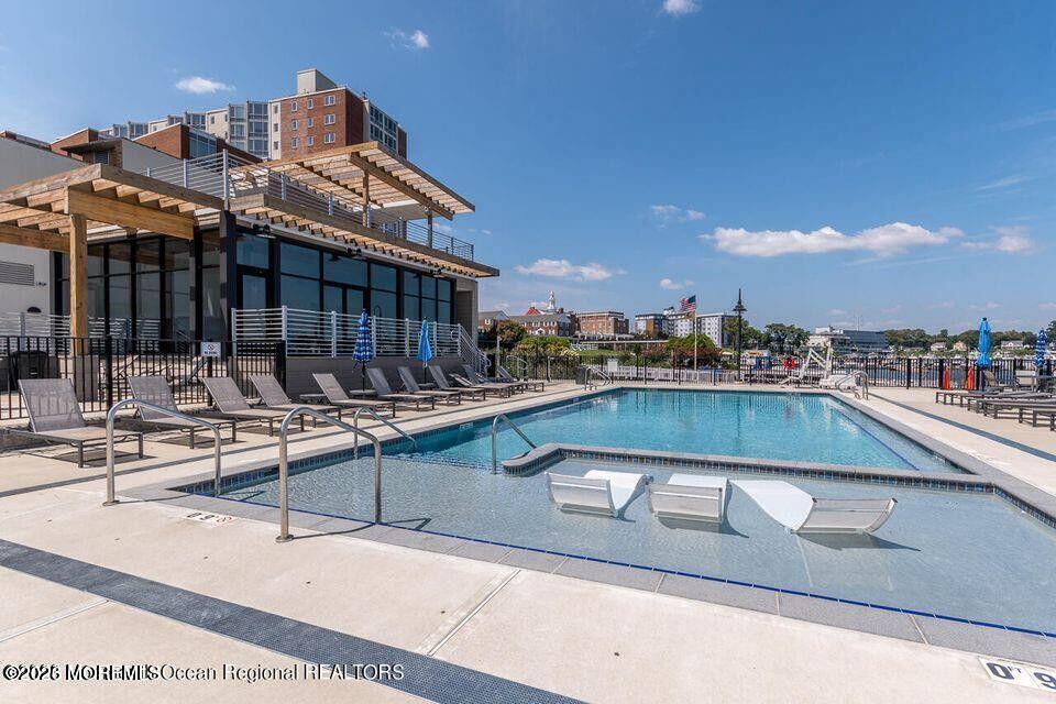 28 Riverside Avenue, Unit 1N Red Bank, NJ 07701 - Photo 36 of 40 a view of swimming pool with outdoor seating and city view