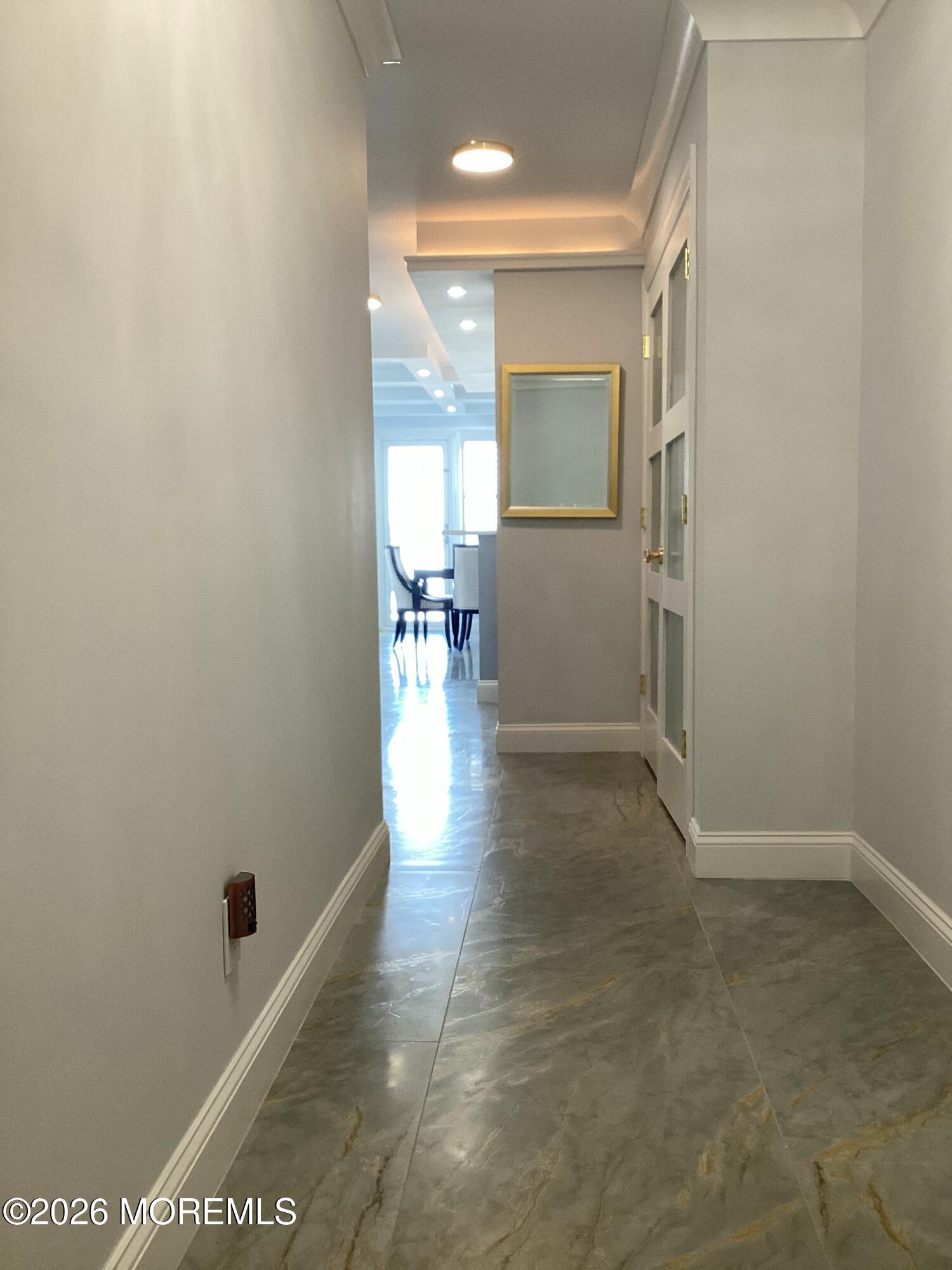 28 Riverside Avenue, Unit 1N Red Bank, NJ 07701 - Photo 4 of 40 a view of a hallway with wooden floor and a bathroom