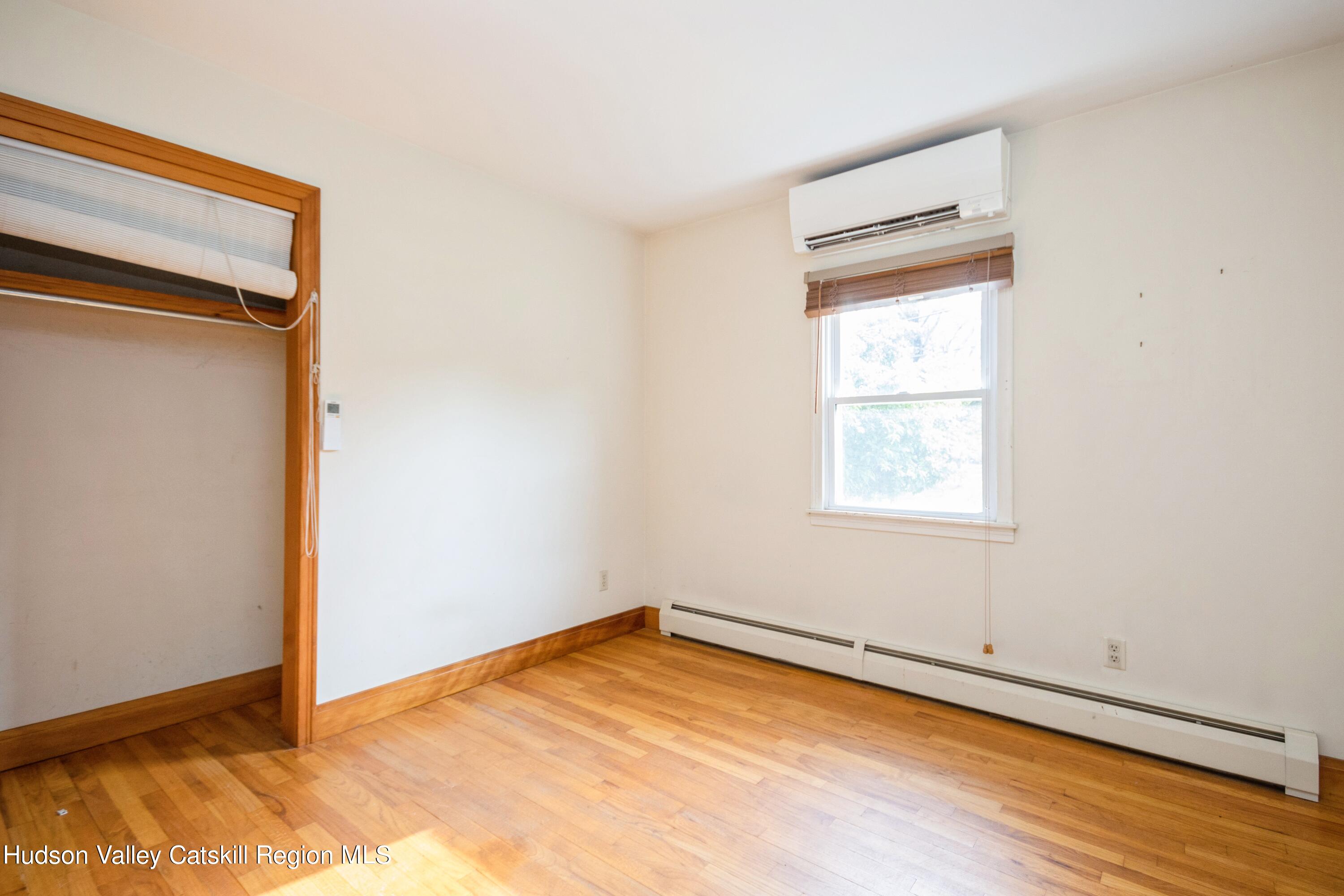 3754 Atwood Road Stone Ridge, NY 12484 - Photo 24 of 36 a view of an empty room with wooden floor and a window