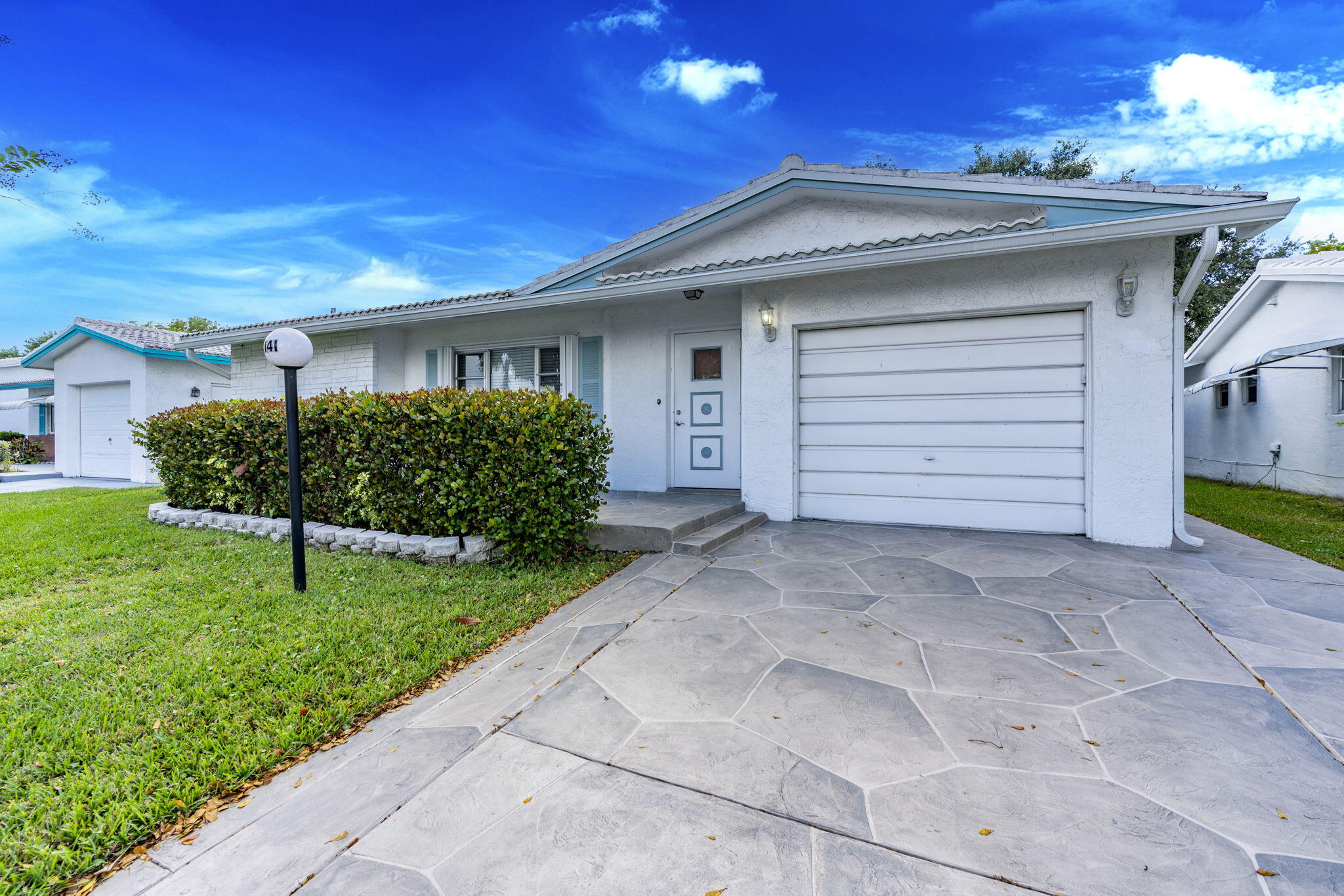 1141 Northwest 90th Way Plantation, FL 33322 - Photo 1 of 75 a front view of a house with a yard and garage