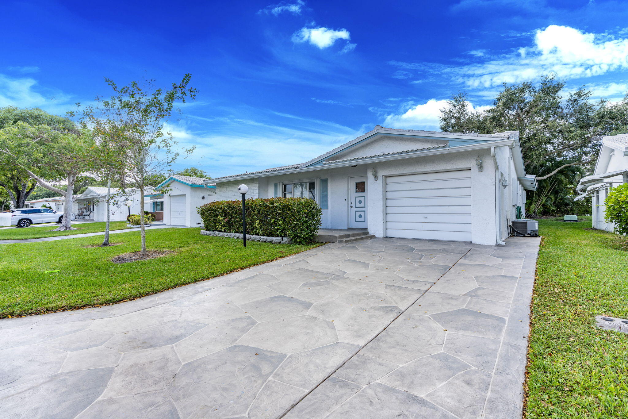 1141 Northwest 90th Way Plantation, FL 33322 - Photo 2 of 75 a front view of a house with a yard and garage