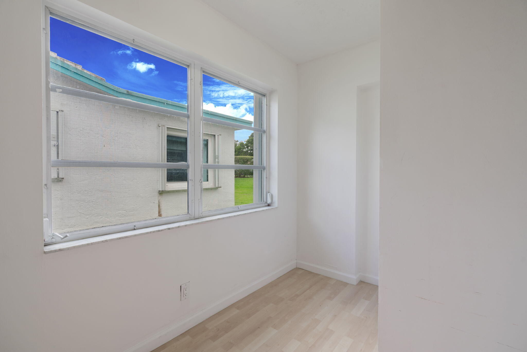 1141 Northwest 90th Way Plantation, FL 33322 - Photo 23 of 75 a view of a room that has a window and wooden floor