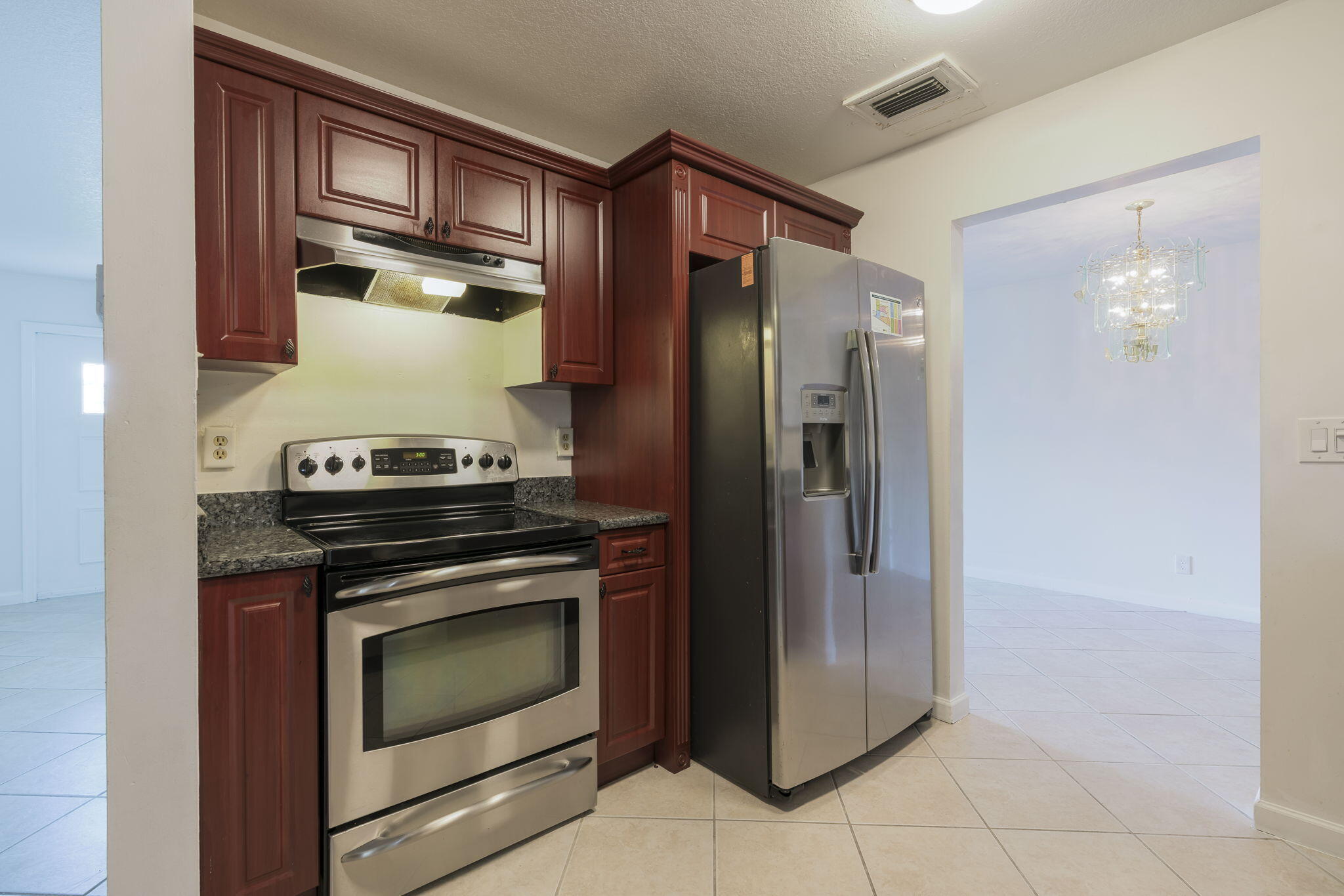 1141 Northwest 90th Way Plantation, FL 33322 - Photo 37 of 75 a kitchen with stainless steel appliances granite countertop a refrigerator and a stove