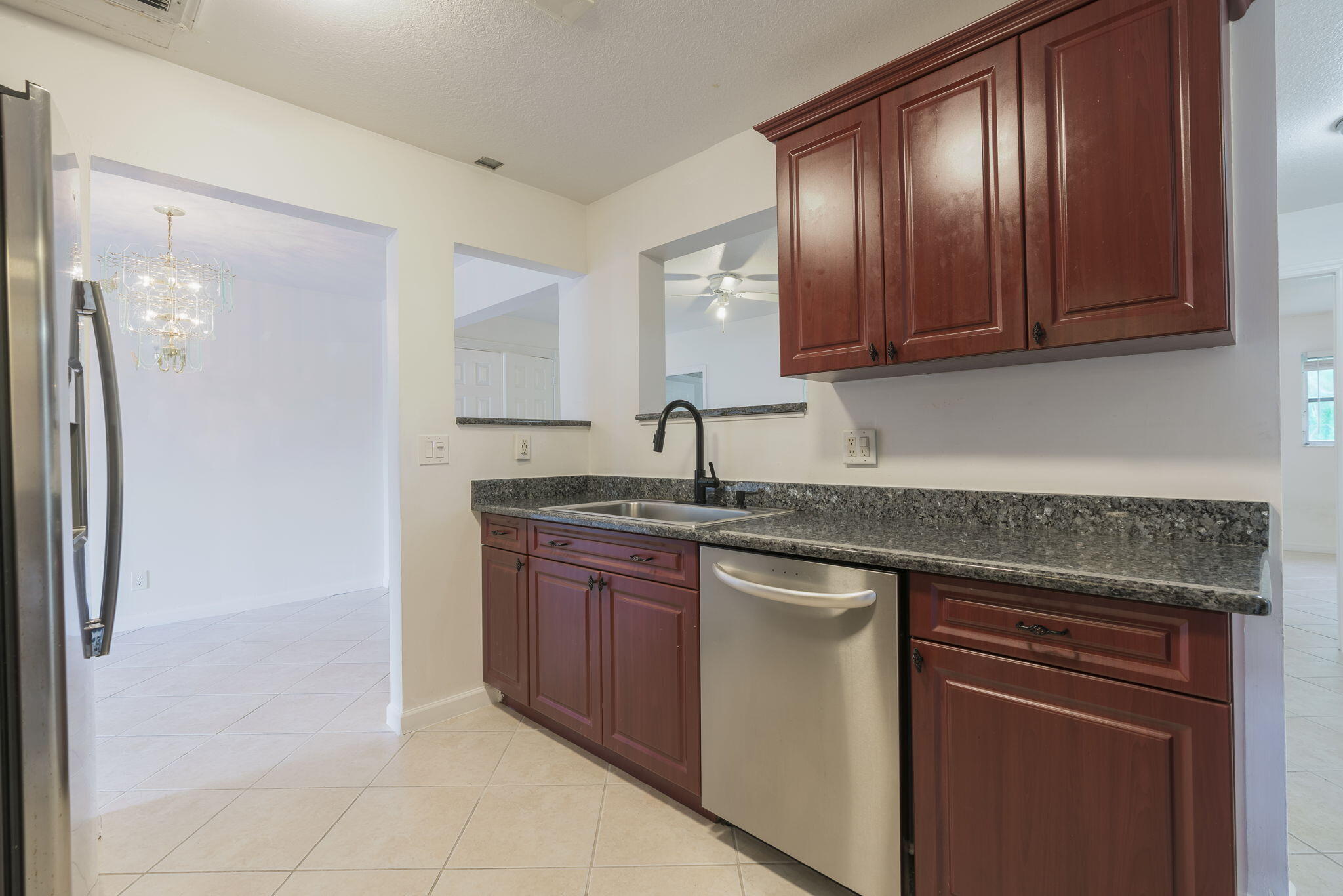 1141 Northwest 90th Way Plantation, FL 33322 - Photo 38 of 75 a kitchen with stainless steel appliances granite countertop wood cabinets a sink and dishwasher