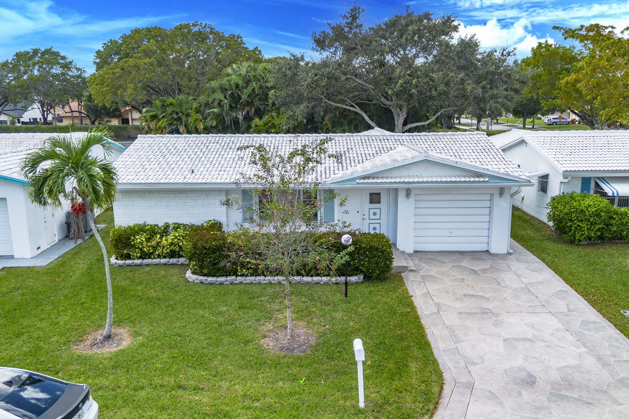 1141 Northwest 90th Way Plantation, FL 33322 - Photo 59 of 75 a front view of a house with a yard and potted plants