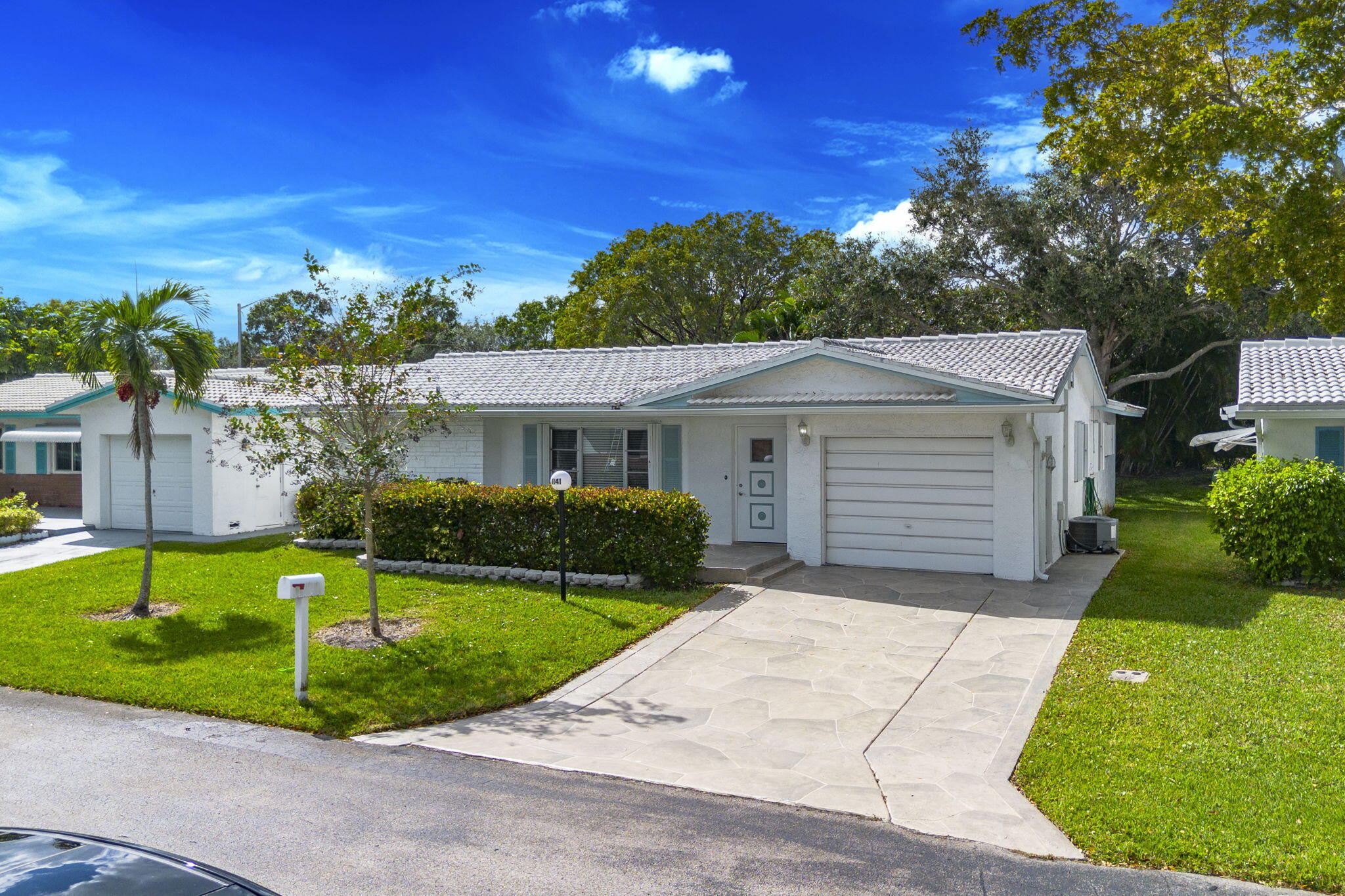 1141 Northwest 90th Way Plantation, FL 33322 - Photo 75 of 75 a view of a white house with a yard plants and large tree