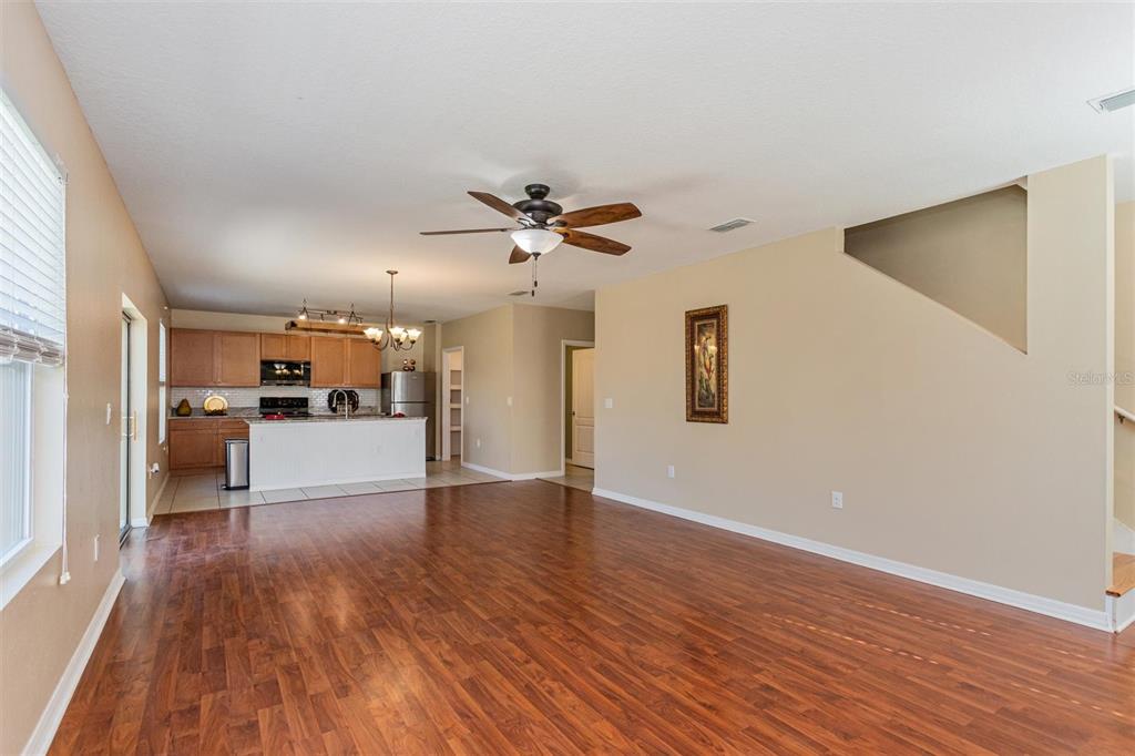 2470 Valhalla Drive Tavares, FL 32778 - Photo 12 of 26 a view of a kitchen with a sink a ceiling fan and wooden floor