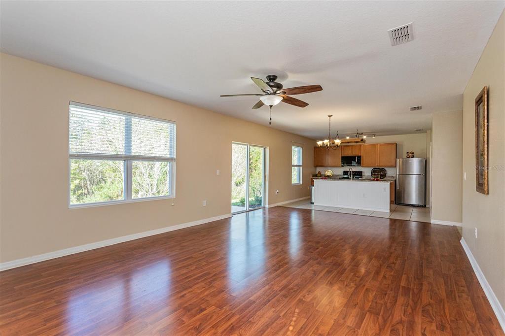 2470 Valhalla Drive Tavares, FL 32778 - Photo 13 of 26 a view of a livingroom with wooden floor and a kitchen