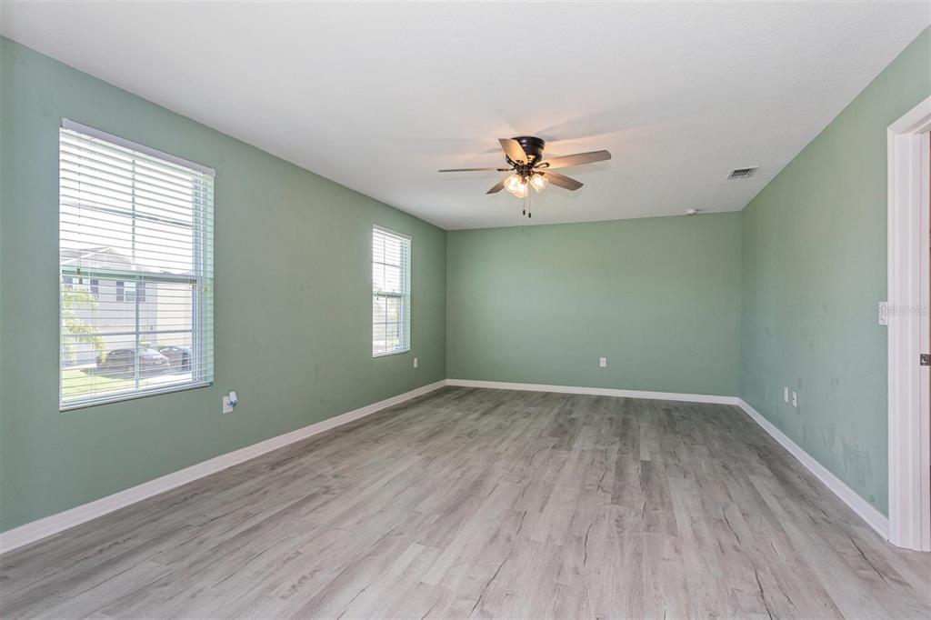 2470 Valhalla Drive Tavares, FL 32778 - Photo 14 of 26 wooden floor in an empty room with a window